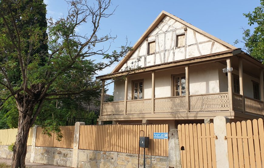 Traditional house with a wooden balcony in Asureti